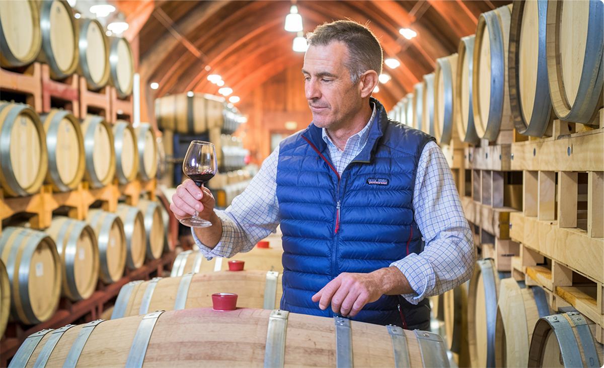 A winemaker overseeing barrels
